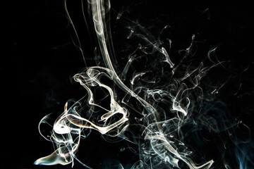 Smoke effect texture. Isolated background. Black and dark backdrop. Smokey fire and mistic effect.