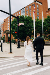 bride and groom walking on the street