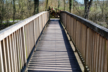 Fototapeta na wymiar wooden pedestrian bridge over the river