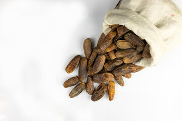 dried dates fruit in a sack bag isolated on white background