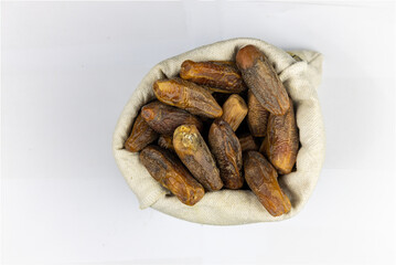 dried dates fruit in a sack bag isolated on white background