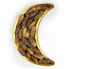 Dried dates fruits arranged in shape of crescent moon. Iftar food and ramadan concept