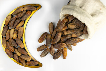 Dried dates fruits arranged in the shape of a crescent moon. Iftar food and Ramadan concept