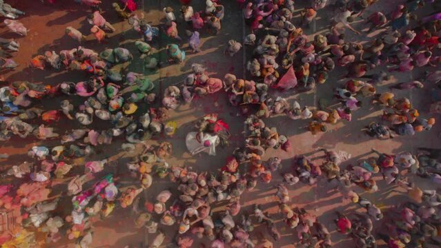Aerial view of people celebrating the Holi Colour festival at Shri And Baba Temple in Nandgaon, Uttar Pradesh, India.
