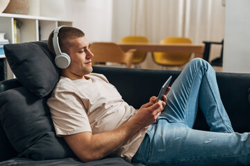 AA Caucasian man enjoys his free time using a tablet alone at home