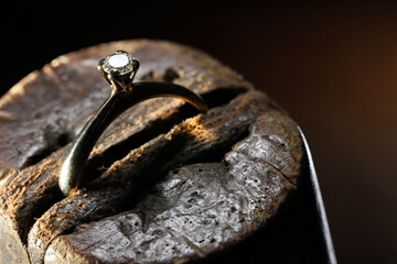 gold ring with brilliant cut diamond in goldsmith workshop