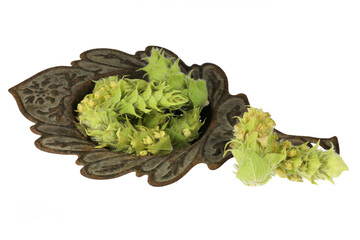 Greek Mountain Tea in a vintage tea strainer isolated on white background