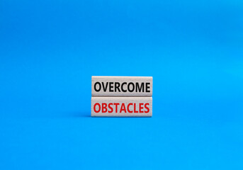 Overcome obstacles symbol. Concept words Overcome obstacles on wooden blocks. Beautiful blue background. Business and Overcome obstacles concept. Copy space.