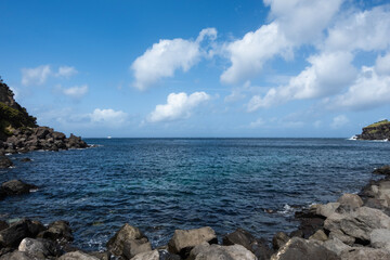 Azores Black Basalt Ocean Shore with Clear Blue Sky and Wispy Clouds