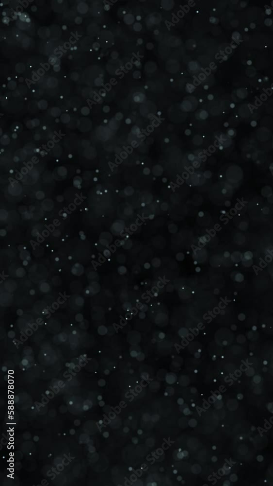 Poster small blurred dots slow motion loop on vertical black background.