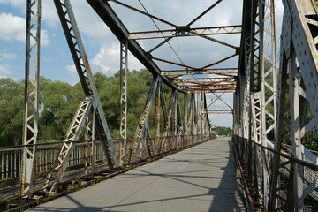 Fototapeta premium Old metal bridge across Dniester river in the city of Halych, western Ukraine
