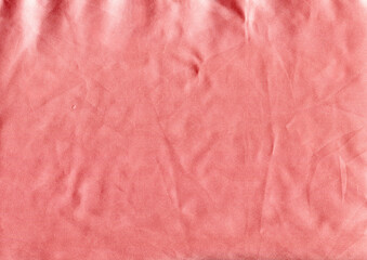 Pink silk fabric. Texture of crumpled fabric with bends.