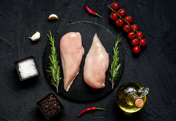 raw chicken breasts on stone background