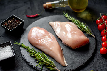 raw chicken breasts on stone background