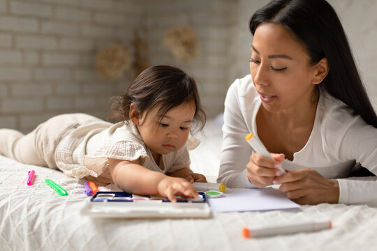Korean Mommy And Baby Daughter Painting Together At Home