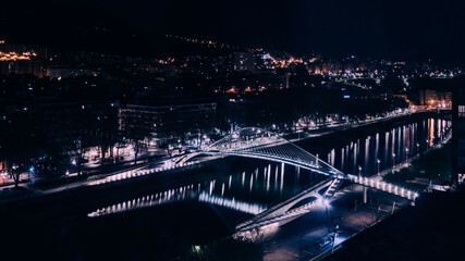 High perspective long exposure view of Zubizuri bridge at night in Bilbao, Spain