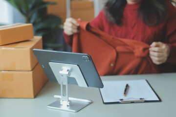 Entrepreneurs Small Business SME Independent men work at home Use smartphones and laptops for commercial checking, online marketing, packing boxes, SME sellers, concept, e-commerce team, online sales