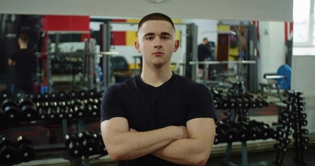 Portrait, fitness and man with arms crossed in gym ready to start workout, training or exercise. Sports, health and face of happy, proud or confident male athlete from Brazil preparing for exercising.