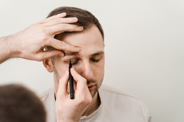 Male blepharoplasty for man markup. Plastic surgeon draws markings on the eyelid before plastic...