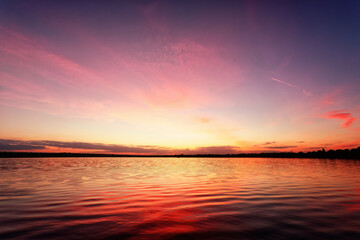 Romantic pink skies reflecting on a calm and serene lake