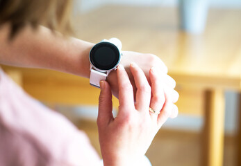 Hands of woman wearing smart watch. Technology and business concept. Modern lifestyle.