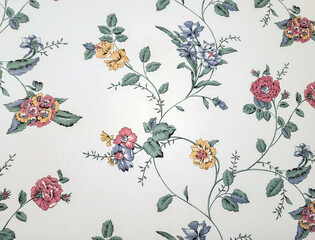 Close up of old-fashioned floral wallpaper pattern on an ivory-colored background