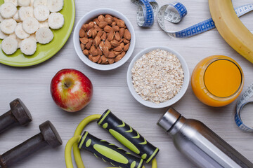 Healthy food. Fruits, almonds, oatmeal, orange juice on a white table. Flat top view