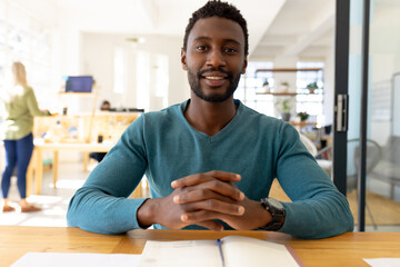 Portrait of happy casual african american businessman having video call in modern office