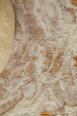 shaping sourdough bread dough into round, boule on floured board