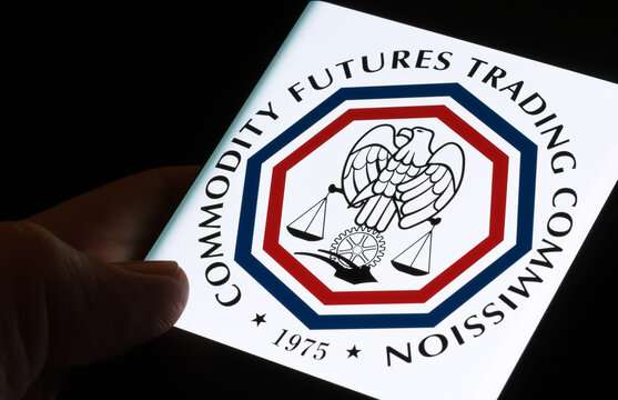 Commodity Futures Trading Commission CFTC logo seen on the screen of smartphone hold in hands in dark. Stafford, United Kingdom, April 3, 2023.