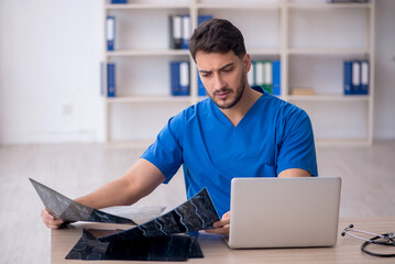 Young doctor radiologist sitting at the hospital