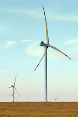 Wind energy. Wind power. Sustainable, renewable energy. Wind turbines generate electricity. Windmill farm on mountain with sunset sky. Green technology. Renewable resource. Sustainable development.