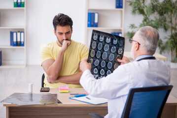 Young male patient visiting old male doctor radiologist