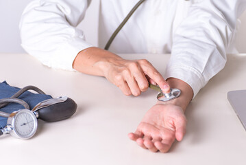 A doctor is checking a blood pressure on a table.