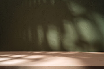 Empty table on khaki green texture wall background. Wood table with abstract shadow on the khaki...