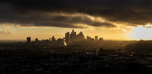 Moody Downtown Los Angeles at Golden Hour with the sun peaking through the clouds 