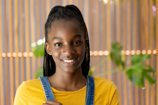 Portrait of happy african american teenager girl looking at camera and smiling