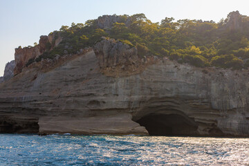 View of the rocky shore from the sea. Mediterranean Sea in Turkey. Popular tourist places. Background