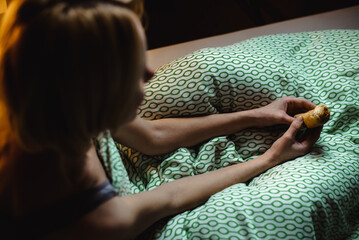 Penis size, shape concept. A woman holds a bun in her hands that looks like a male phallus. Funny...