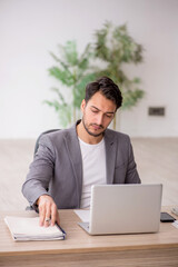 Young male employee working in the office