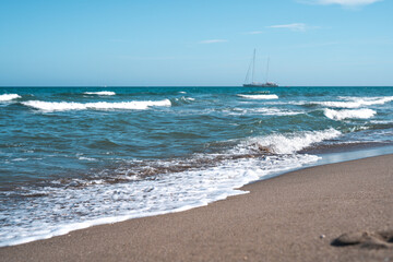 Fototapeta na wymiar Sailing yacht stands on the sea horizon on a sunny summer day