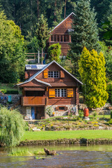 Fototapeta na wymiar Rural holiday cabins along Luznice river, Czech Republic