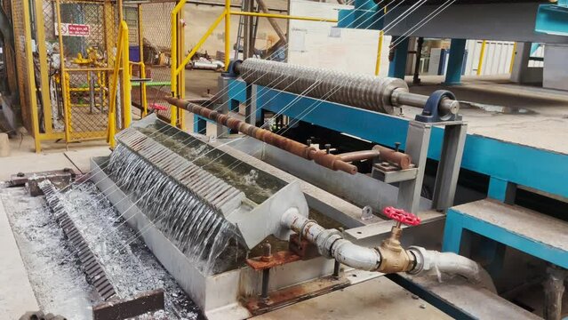 Machine pulling galvanized wire in production process in industrial factory