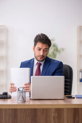 Young male employee working in the office