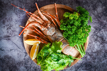 fresh lobster or rock lobster seafood with herb and spices lemon coriander parsley lettuce salad,...