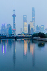 Skyscrapers of Pudong behind historical Waibaidu bridge in Shanghai, China