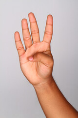 Naklejka premium Hand shows number four , Number four index finger isolated background