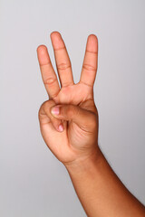 Hand shows number three , Number three index finger isolated background