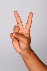 Hand shows number two , Number two index finger isolated background