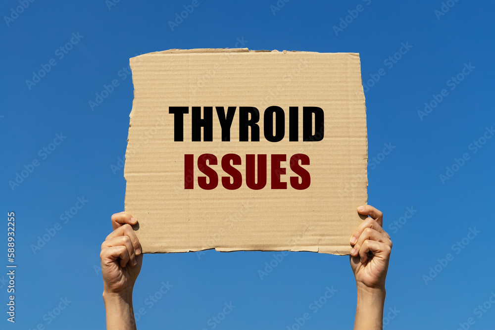 Poster thyroid issues text on box paper held by 2 hands with isolated blue sky background. this message boa